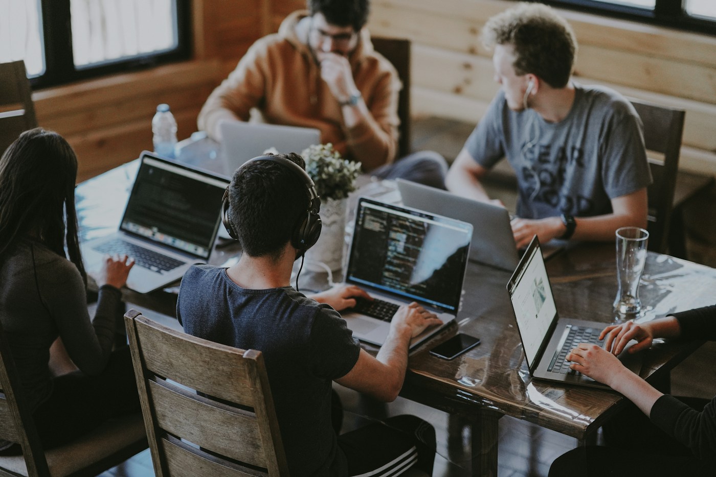 A collaborative team working together around a studio table